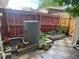The back yard features mature plants and a red fence bordering the perimeter at 8624 Mariposa St, Thornton, CO 80260