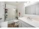 Bathroom featuring white cabinets, quartz countertops, updated mirror and hardware, and a walk-in shower at 8624 Mariposa St, Thornton, CO 80260