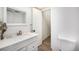 Clean bathroom with white cabinets, marble countertops, a new sink and toilet at 8624 Mariposa St, Thornton, CO 80260
