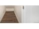 Narrow hallway with laminate flooring and white trim at 8624 Mariposa St, Thornton, CO 80260