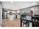 Bright kitchen with white cabinets, stainless steel appliances, and dining area at 8624 Mariposa St, Thornton, CO 80260