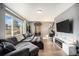 Stylish living room features large window, comfortable sofa, and a fireplace at 8624 Mariposa St, Thornton, CO 80260