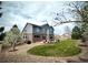 Lovely backyard with a patio, lush lawn, mature trees, and professional landscaping, perfect for outdoor living at 15960 E Aberdeen Ave, Centennial, CO 80016