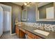 Bathroom features double sinks, vanity, mosaic backsplash, and attached shower at 15960 E Aberdeen Ave, Centennial, CO 80016