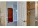 View of a tiled shower with a soap dish through a doorway and glimpse of an office with bookshelves at 15960 E Aberdeen Ave, Centennial, CO 80016