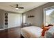 Well-lit bedroom features hardwood floors, ample closet space, and a ceiling fan at 15960 E Aberdeen Ave, Centennial, CO 80016