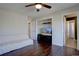 Bedroom includes hardwood floors, a ceiling fan, and ample space for storage and relaxation at 15960 E Aberdeen Ave, Centennial, CO 80016