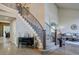 Grand foyer with a staircase, chandelier, and tasteful decor showcasing an inviting entrance and warm ambiance at 15960 E Aberdeen Ave, Centennial, CO 80016
