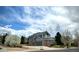 Beautiful two-story home with a three car garage, brick and siding exterior, and a well-maintained lawn at 15960 E Aberdeen Ave, Centennial, CO 80016