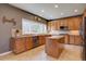 Well-equipped kitchen featuring granite countertops, custom cabinets, a center island, and modern appliances with a view at 15960 E Aberdeen Ave, Centennial, CO 80016
