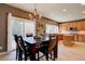 Bright kitchen and dining area featuring modern appliances, custom cabinets, tile floors, and an adjacent dining table at 15960 E Aberdeen Ave, Centennial, CO 80016