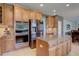 Modern kitchen with stainless steel appliances, custom cabinets, an island, and sleek fixtures for cooking needs at 15960 E Aberdeen Ave, Centennial, CO 80016