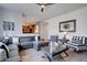 Living room showcases an open concept with hardwood floors, stylish furniture, and seamless flow into the kitchen at 15960 E Aberdeen Ave, Centennial, CO 80016