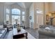 Bright and airy living room with large windows, comfortable seating, hardwood floors, and a welcoming atmosphere at 15960 E Aberdeen Ave, Centennial, CO 80016