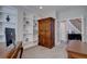 Home office with built-in bookshelves, a desk, and an armoire with French doors leading to the hallway at 15960 E Aberdeen Ave, Centennial, CO 80016