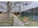 Exterior view of pickleball courts beside a tree lined walkway, for recreation and exercise at 15960 E Aberdeen Ave, Centennial, CO 80016