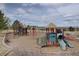 Community playground with multiple play structures and slides on a wood chip ground covering at 15960 E Aberdeen Ave, Centennial, CO 80016