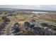 Aerial view of a new housing development featuring modern homes, parks, and lake views at 17233 W 93Rd Pl, Arvada, CO 80007