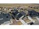 Charming aerial view of a home showcasing its architectural style, dark roof, and placement within a residential neighborhood at 17233 W 93Rd Pl, Arvada, CO 80007