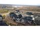 An aerial view of a new residential community near a lake, showcasing modern architecture and planned landscaping at 17233 W 93Rd Pl, Arvada, CO 80007