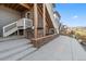 Backyard area with a built-in grill, stone accents, and stairs to the upper levels at 17233 W 93Rd Pl, Arvada, CO 80007