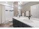 Bathroom boasts a double vanity and a shower/tub combination with sleek white tile at 17233 W 93Rd Pl, Arvada, CO 80007