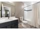 Modern bathroom with a sleek vanity, toilet, and a shower/tub combo with tiled surround at 17233 W 93Rd Pl, Arvada, CO 80007