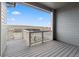 A cozy deck offers panoramic views of the surrounding landscape on a clear day at 17233 W 93Rd Pl, Arvada, CO 80007