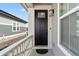 Welcoming front door with black finish, enhanced by white trim and complemented by a stylish outdoor light fixture at 17233 W 93Rd Pl, Arvada, CO 80007