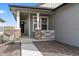 Charming front porch features stone columns, grey siding, and a walkway leading to a welcoming front door at 17233 W 93Rd Pl, Arvada, CO 80007