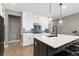 Modern kitchen features an island, stainless steel appliances, and eye-catching backsplash at 17233 W 93Rd Pl, Arvada, CO 80007