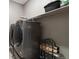 A convenient laundry room includes a washer and dryer with storage space at 17233 W 93Rd Pl, Arvada, CO 80007