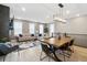 Open living area features modern decor, wood floors, and plenty of natural light from large windows at 17233 W 93Rd Pl, Arvada, CO 80007