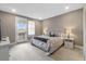 Comfortable main bedroom with a door leading to a private balcony and scenic views at 17233 W 93Rd Pl, Arvada, CO 80007