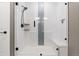 Beautifully tiled shower with glass door and a built-in bench for relaxing at 17233 W 93Rd Pl, Arvada, CO 80007