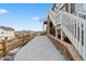 Outdoor walkway with stone accents leading to backyard with views of houses in the distance at 17233 W 93Rd Pl, Arvada, CO 80007