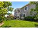 Well-kept lawn in a large backyard with a patio outside a house with gray siding at 20293 E Shady Ridge Rd, Parker, CO 80134