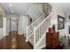 Inviting foyer with hardwood floors, staircase, and neutral decor, creating a warm and welcoming entrance at 20293 E Shady Ridge Rd, Parker, CO 80134