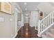Bright foyer with hardwood floors, staircase, and arched doorways, creating a welcoming and elegant entrance at 20293 E Shady Ridge Rd, Parker, CO 80134