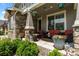 Inviting front porch featuring comfortable seating, stylish decor, and lush greenery, perfect for relaxing outdoors at 20293 E Shady Ridge Rd, Parker, CO 80134
