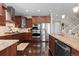 Modern kitchen featuring dark wood cabinetry, stainless steel appliances, and granite countertops at 20293 E Shady Ridge Rd, Parker, CO 80134
