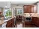 Well-appointed kitchen featuring dark wood cabinets, granite countertops, and stainless steel appliances at 20293 E Shady Ridge Rd, Parker, CO 80134