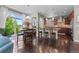 Open-concept kitchen with an island, dark wood cabinets, stainless steel appliances, and an adjoining dining area at 20293 E Shady Ridge Rd, Parker, CO 80134