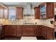 Close-up showcasing the kitchen's updated appliances, granite countertops, and dark wood cabinets at 20293 E Shady Ridge Rd, Parker, CO 80134