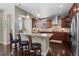 Spacious kitchen with a large island, dark wood cabinets, granite countertops, and stainless steel appliances at 20293 E Shady Ridge Rd, Parker, CO 80134