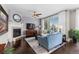 Bright living room with large windows, fireplace, and comfortable blue seating, perfect for relaxation and gatherings at 20293 E Shady Ridge Rd, Parker, CO 80134