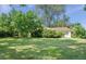 Extensive backyard featuring a well-maintained lawn, mature trees, and shrubbery, complemented by a single-story home at 6235 E 6Th Avenue Pkwy, Denver, CO 80220