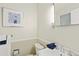 Cozy half-bathroom with white fixtures and a soft, neutral color palette at 6235 E 6Th Avenue Pkwy, Denver, CO 80220