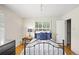 Bedroom with hardwood floors, a black metal bed frame, and shuttered windows at 6235 E 6Th Avenue Pkwy, Denver, CO 80220
