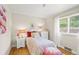 Cozy bedroom with hardwood floors, natural light from the window, and floral bedding with decorative lamps at 6235 E 6Th Avenue Pkwy, Denver, CO 80220
